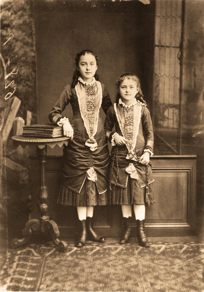 Young Céline Martin and Thérèse of Lisieux pose together.