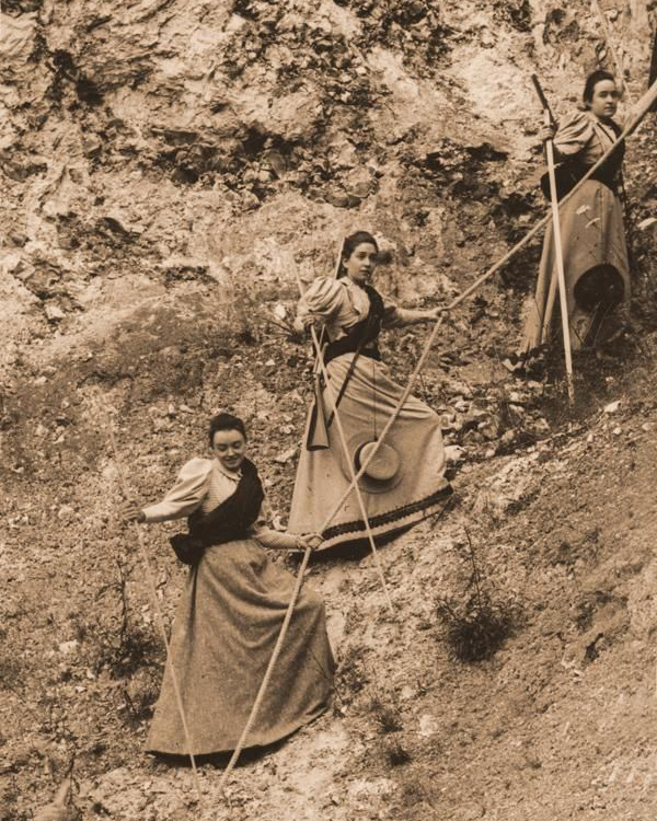 Céline Martin leads her cousin Marie Guérin and sister Jeanne outdoors.