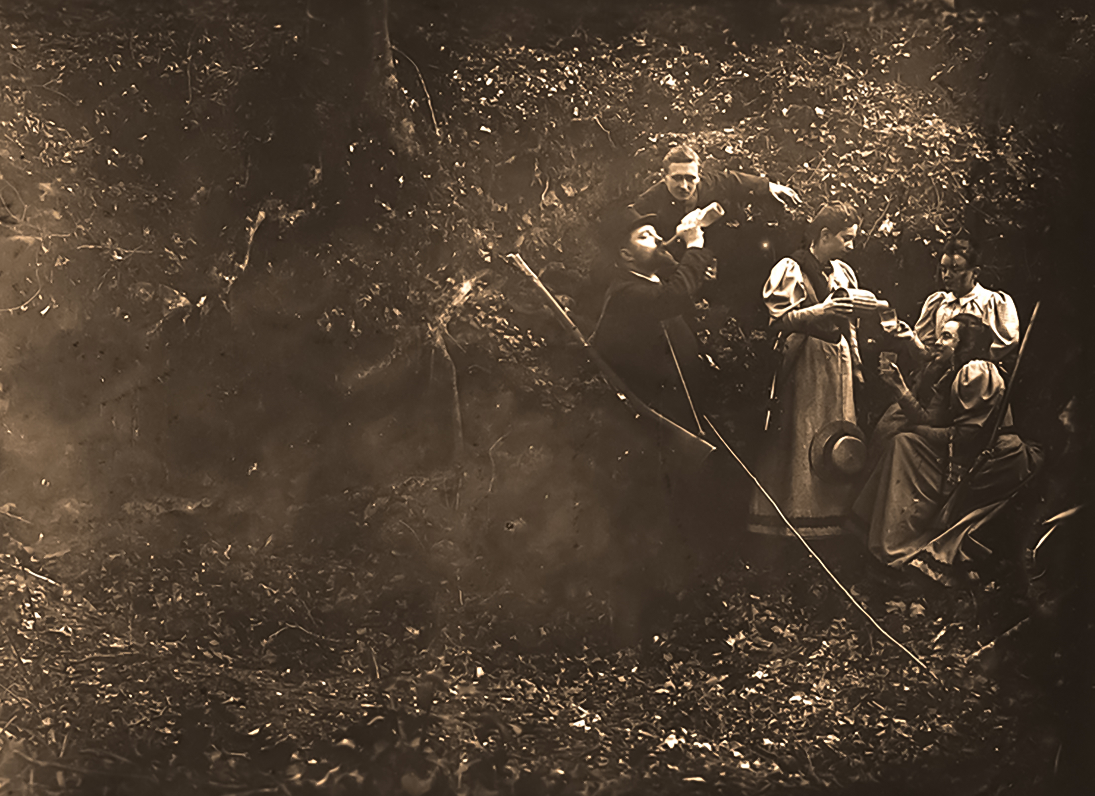 The costumed expedition party pauses for a staged meal in the woods.